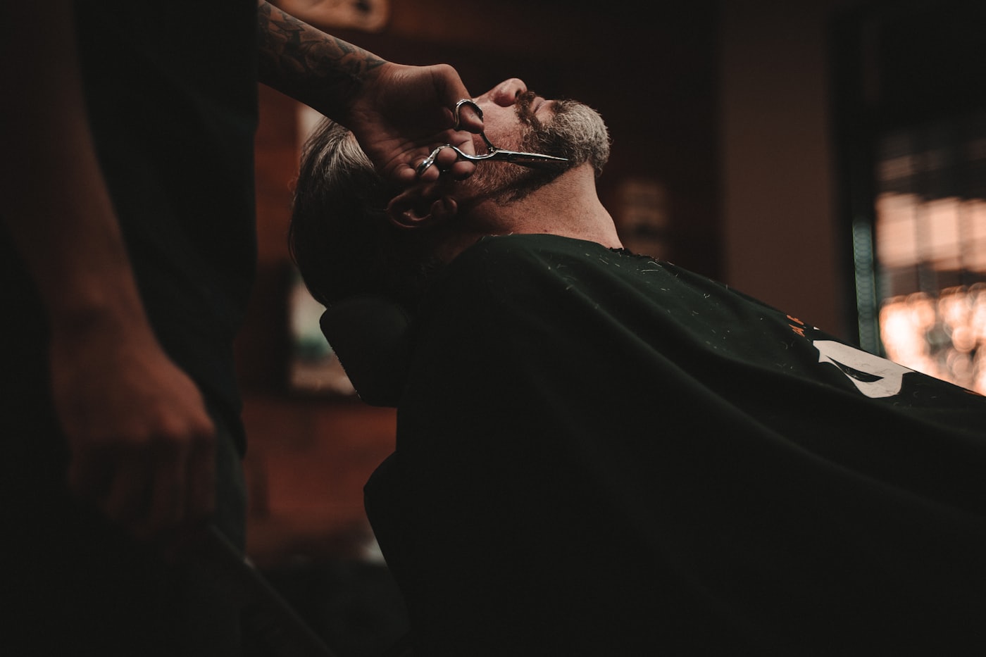 Barber giving a client a precise haircut